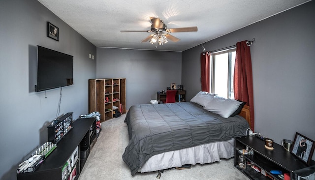 bedroom featuring a textured ceiling, carpet floors, and ceiling fan