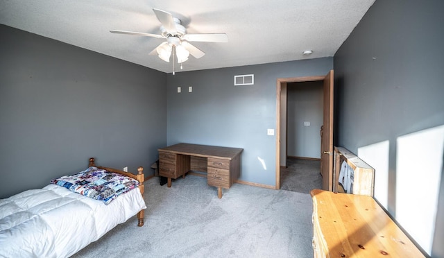 carpeted bedroom featuring a textured ceiling and ceiling fan