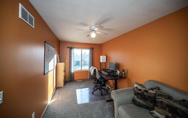 office with ceiling fan, carpet, and a textured ceiling