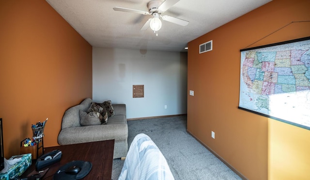 sitting room with carpet flooring, a textured ceiling, and ceiling fan