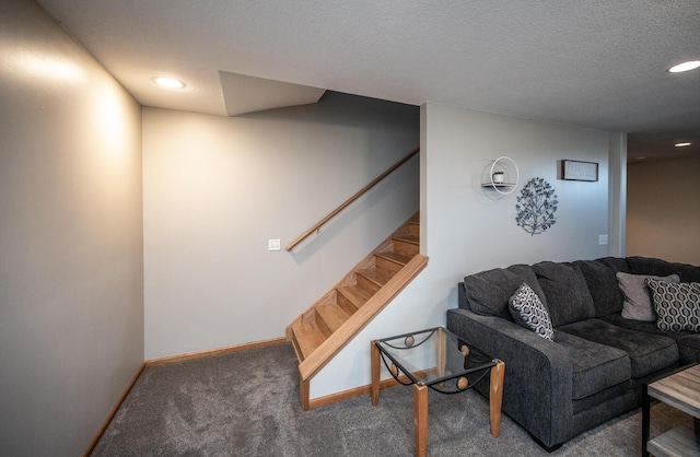 carpeted living room featuring a textured ceiling