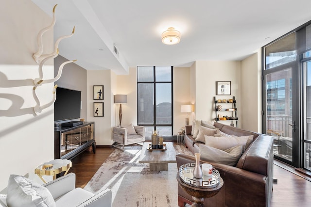 living room featuring floor to ceiling windows and dark hardwood / wood-style floors