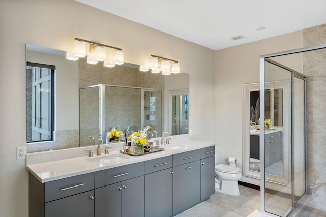 bathroom featuring vanity, a shower with door, and toilet