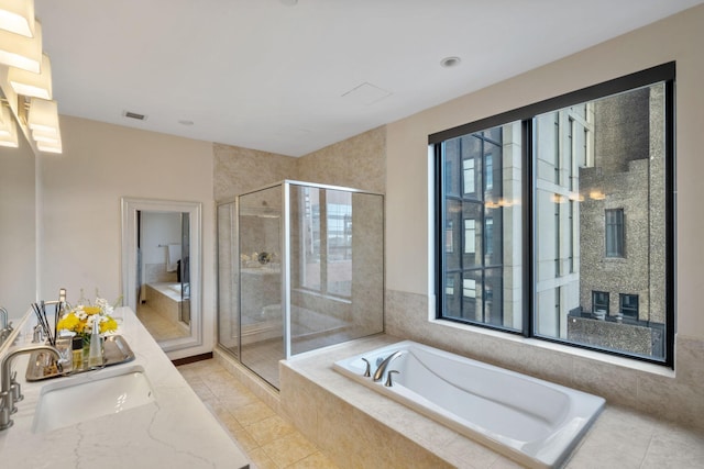 bathroom with vanity, plus walk in shower, and tile patterned flooring