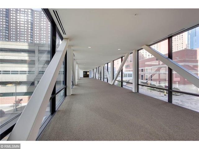 hall with floor to ceiling windows