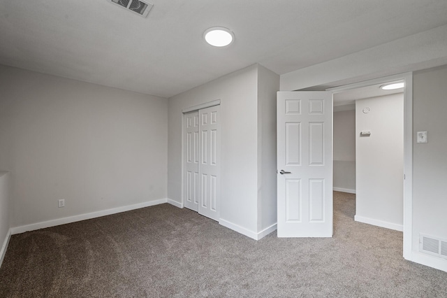 unfurnished bedroom with baseboards, visible vents, and carpet floors