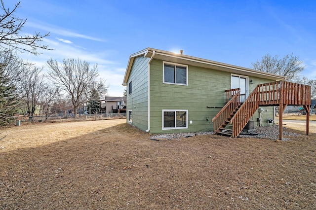 back of house with stairway, a deck, and fence