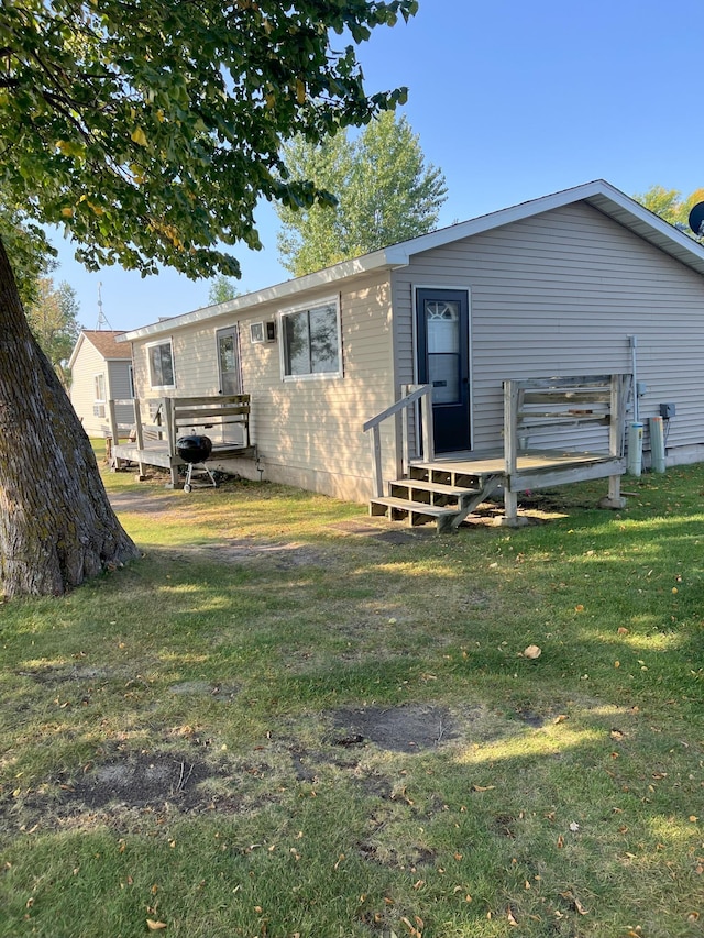 rear view of property featuring a yard