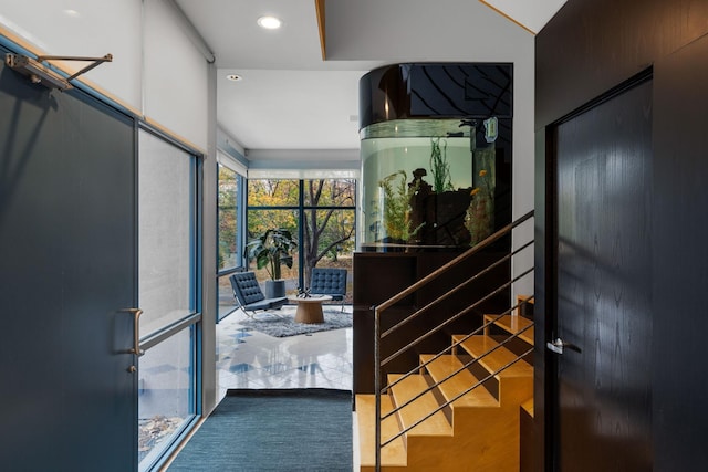 interior space with recessed lighting, wood finished floors, and stairs