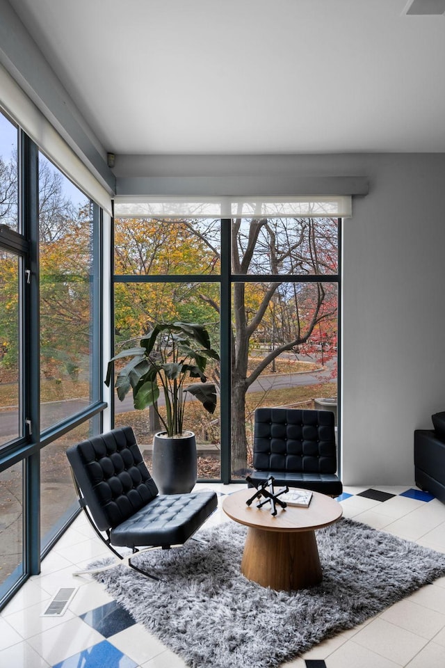 living area featuring a wealth of natural light and tile patterned floors