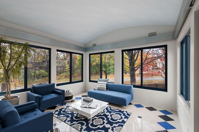 sunroom / solarium featuring a healthy amount of sunlight, visible vents, and vaulted ceiling