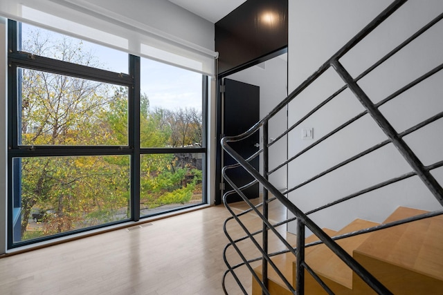 staircase featuring visible vents and wood finished floors