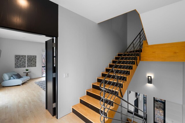 stairs featuring wood finished floors