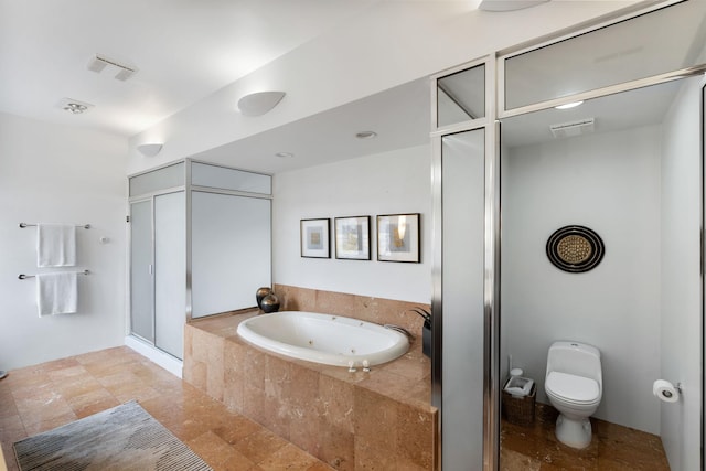 full bathroom featuring a whirlpool tub, a stall shower, visible vents, and toilet