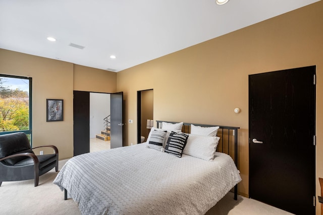 bedroom featuring light colored carpet and recessed lighting