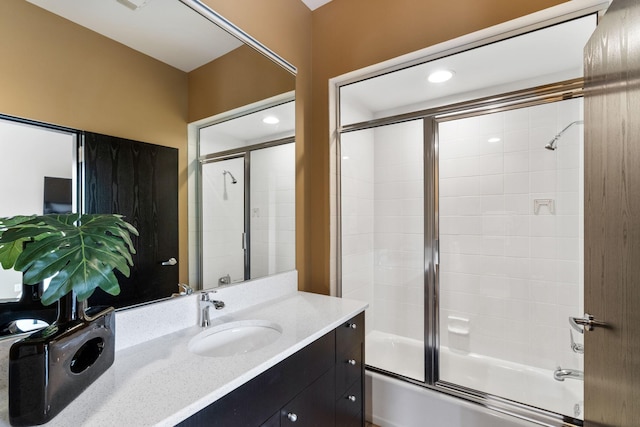 full bath featuring recessed lighting, enclosed tub / shower combo, and vanity