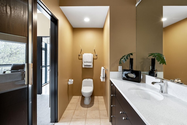 bathroom with tile patterned flooring, vanity, and toilet