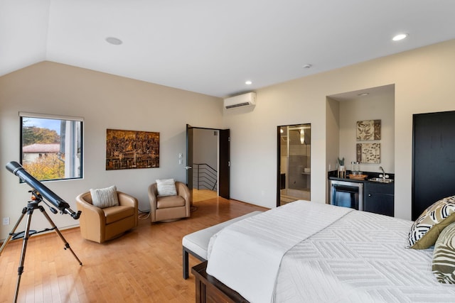 bedroom with lofted ceiling, a wall unit AC, recessed lighting, light wood finished floors, and indoor wet bar