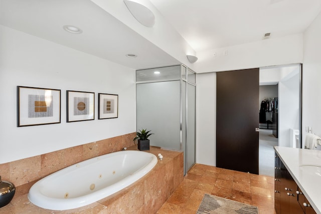 1128 Kenwood Pkwy, Minneapolis, MN 55403 - bathroom featuring recessed lighting, a tub with jets, a shower stall, and vanity