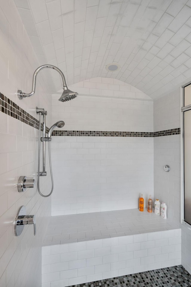 1128 Kenwood Pkwy, Minneapolis, MN 55403 - bathroom featuring vaulted ceiling and tiled shower