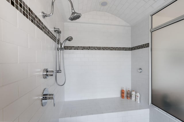 1128 Kenwood Pkwy, Minneapolis, MN 55403 - bathroom with vaulted ceiling and a tile shower