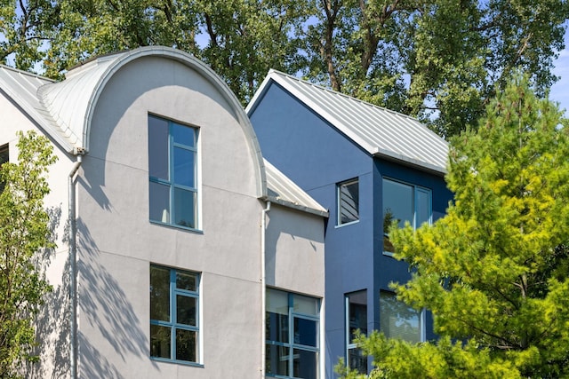 1128 Kenwood Pkwy, Minneapolis, MN 55403 - view of side of home with stucco siding, metal roof, and a standing seam roof