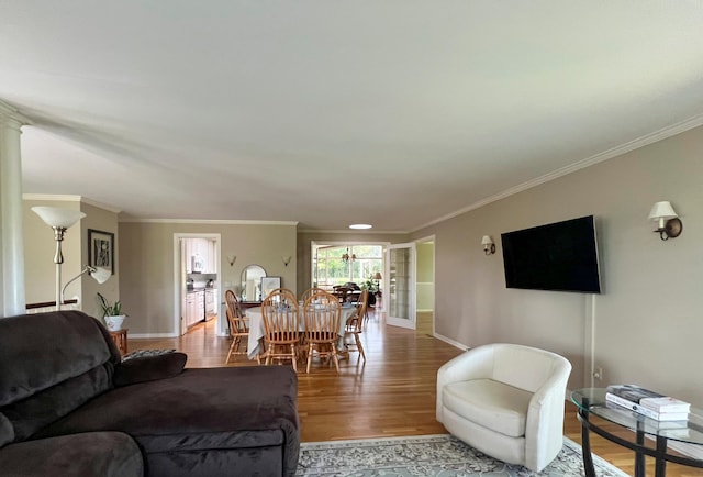 living room featuring ornamental molding and light wood-type flooring