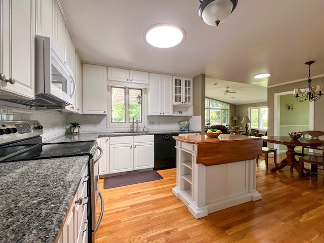 kitchen featuring electric stove, sink, white cabinetry, and dishwasher