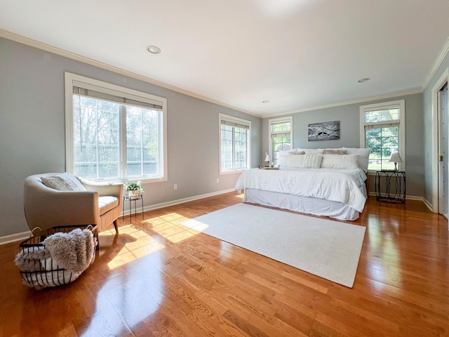 bedroom featuring ornamental molding and light hardwood / wood-style floors