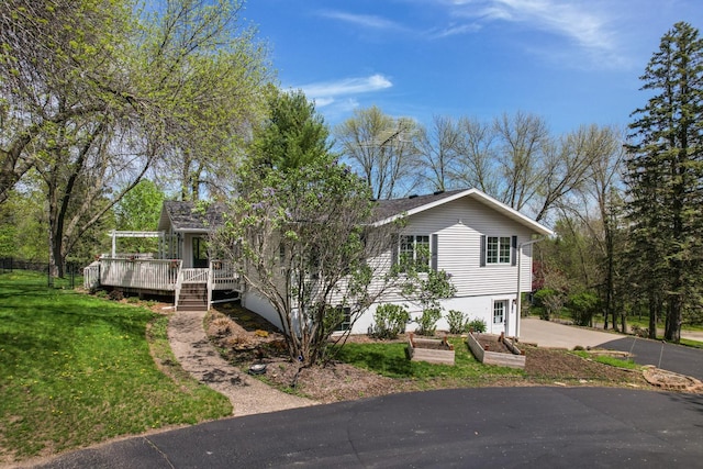 view of front of house with a front lawn and a deck