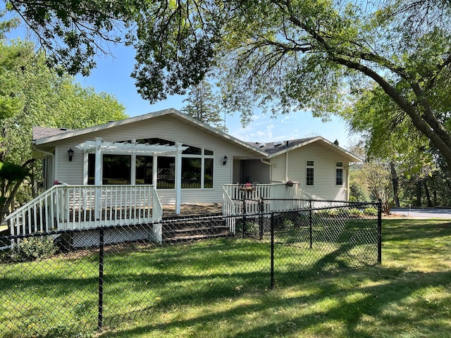 ranch-style house with a wooden deck, a pergola, and a front lawn