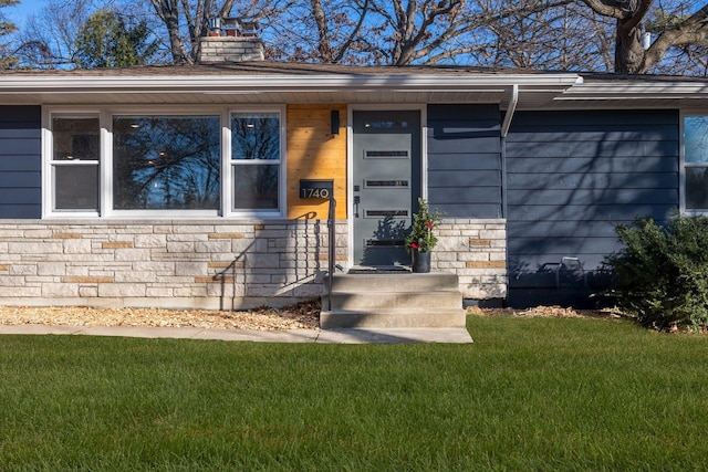 doorway to property with a yard