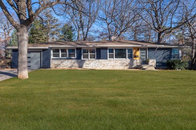 single story home with a garage and a front lawn