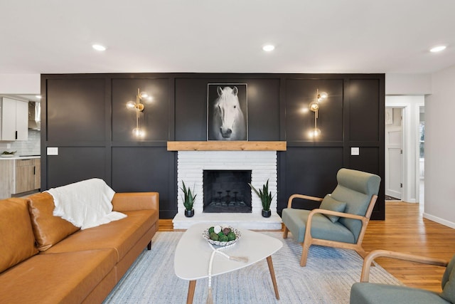 living room featuring a fireplace and light hardwood / wood-style floors