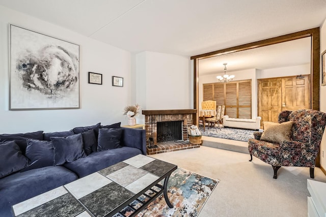 living room with a notable chandelier, a brick fireplace, and carpet