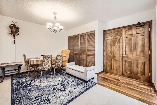 sitting room featuring hardwood / wood-style flooring, a notable chandelier, and a textured ceiling