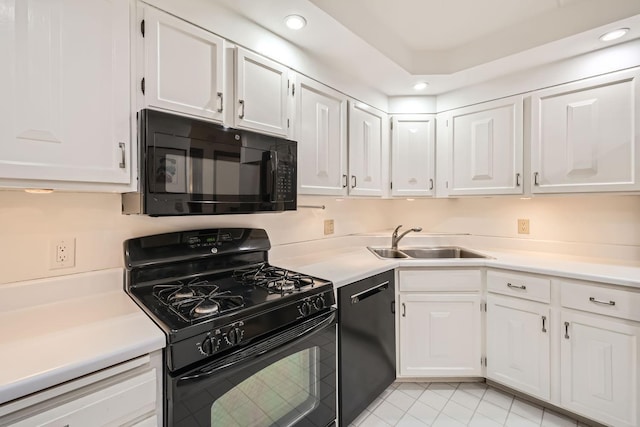 kitchen featuring white cabinetry, sink, light tile patterned floors, and black appliances