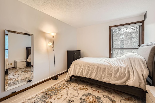 carpeted bedroom with a textured ceiling