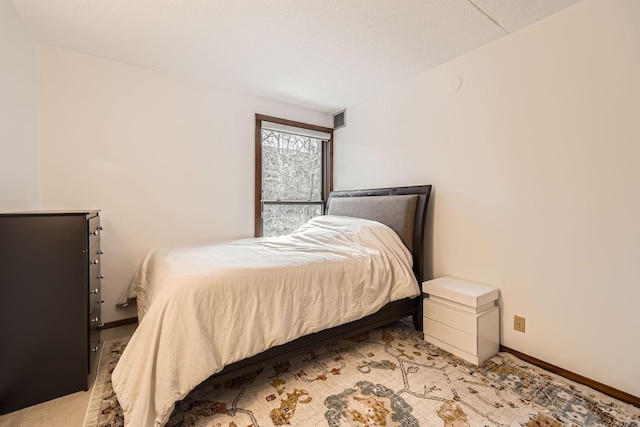 bedroom featuring light carpet