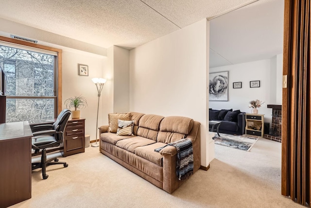 home office with light carpet and a textured ceiling