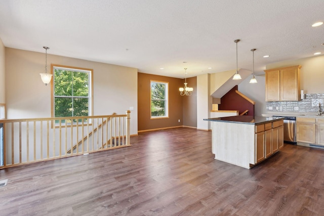 kitchen featuring tasteful backsplash, dishwasher, dark wood-type flooring, and light brown cabinets