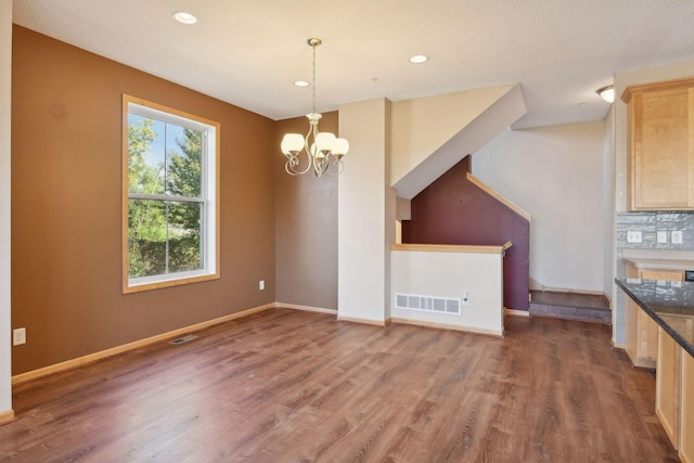 interior space featuring a chandelier and dark hardwood / wood-style flooring