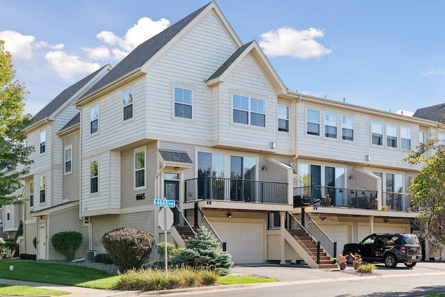 multi unit property featuring cooling unit and a garage