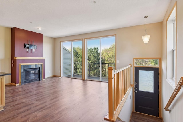 interior space with hardwood / wood-style flooring, plenty of natural light, and a textured ceiling