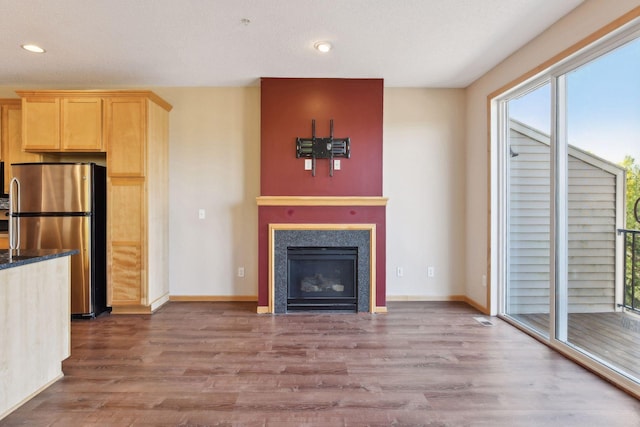 unfurnished living room featuring hardwood / wood-style flooring