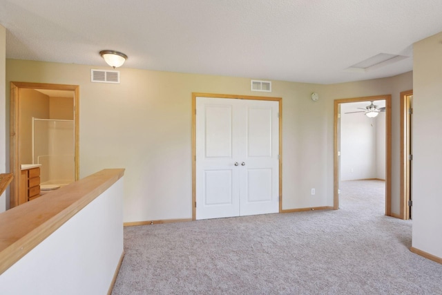 hallway featuring light carpet