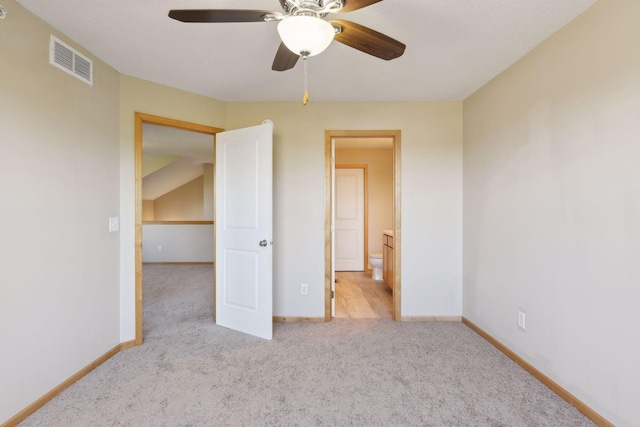 unfurnished bedroom featuring ceiling fan and light carpet