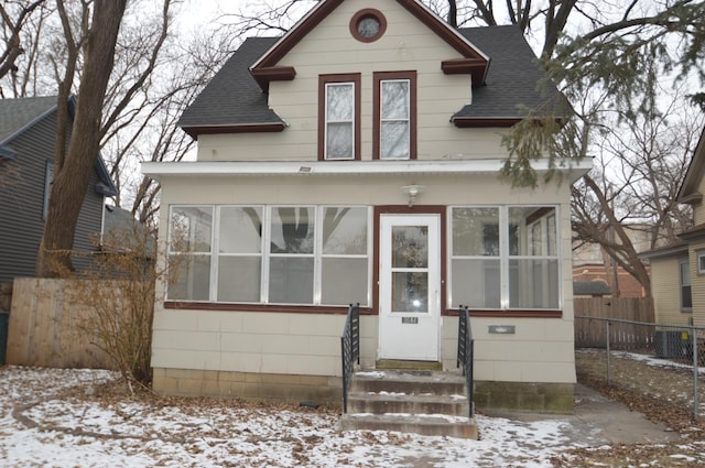 view of front of property featuring a sunroom and central air condition unit