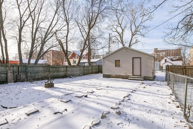 view of snow covered back of property