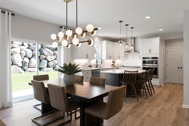 dining space with light hardwood / wood-style flooring